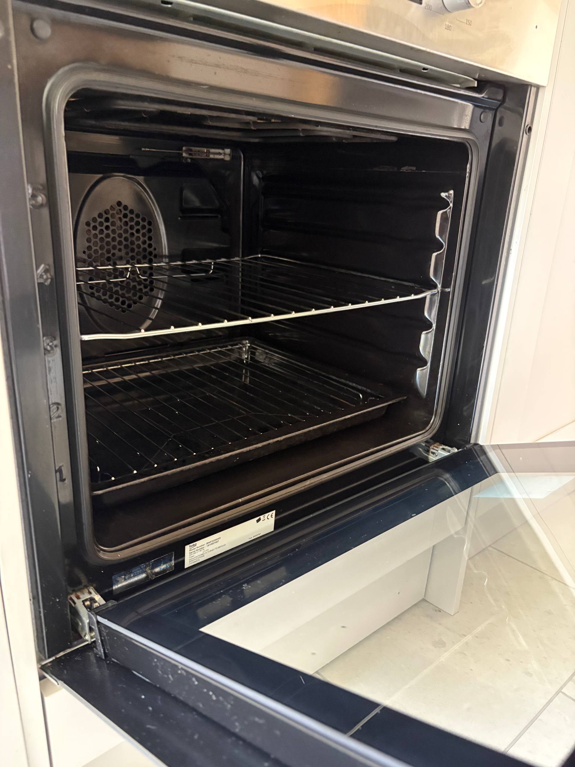 The same oven interior, racks and door glass after cleaning