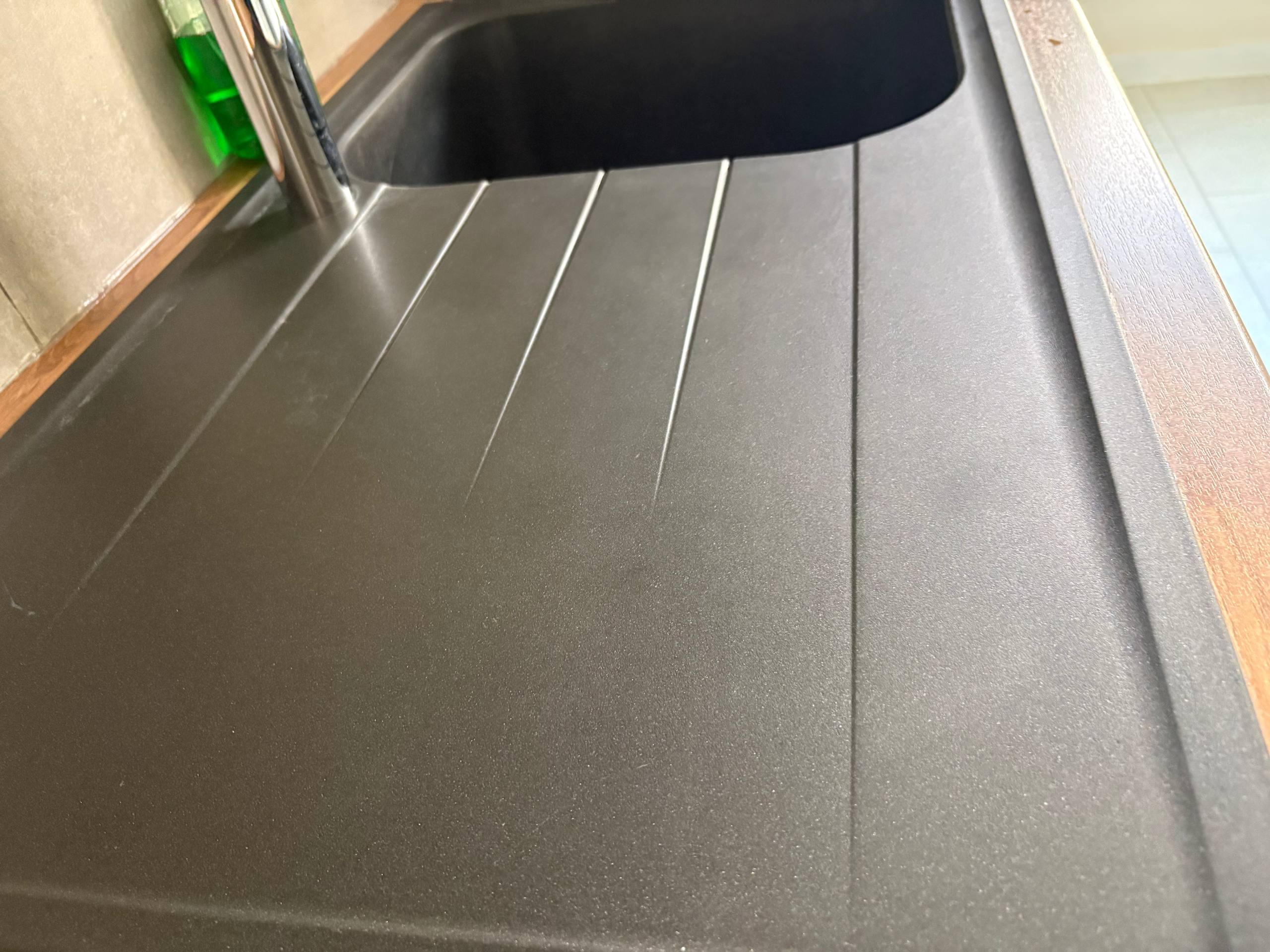 Tiled kitchen floor photographed after cleaning