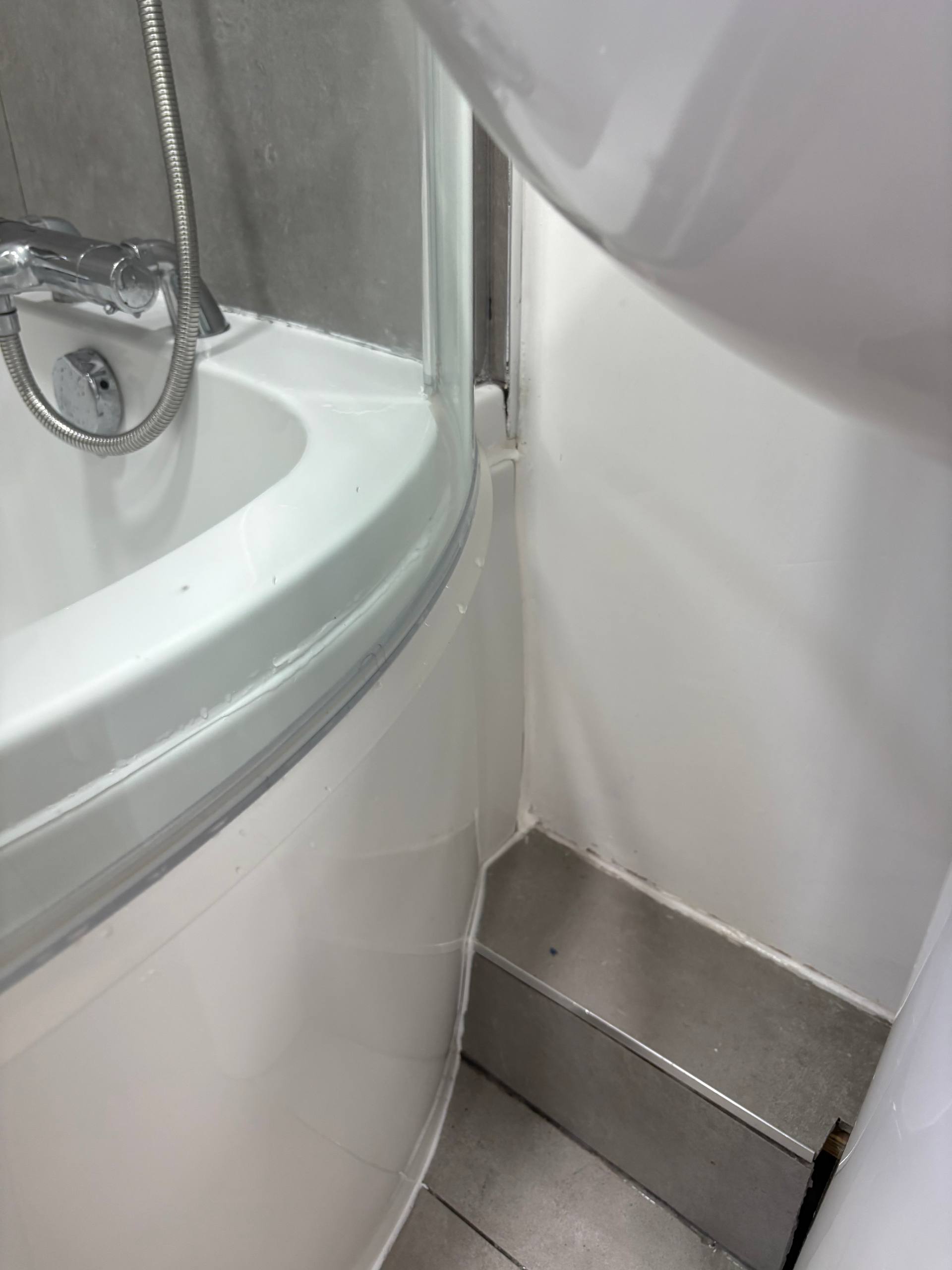 Bath and shower screen area photographed after cleaning